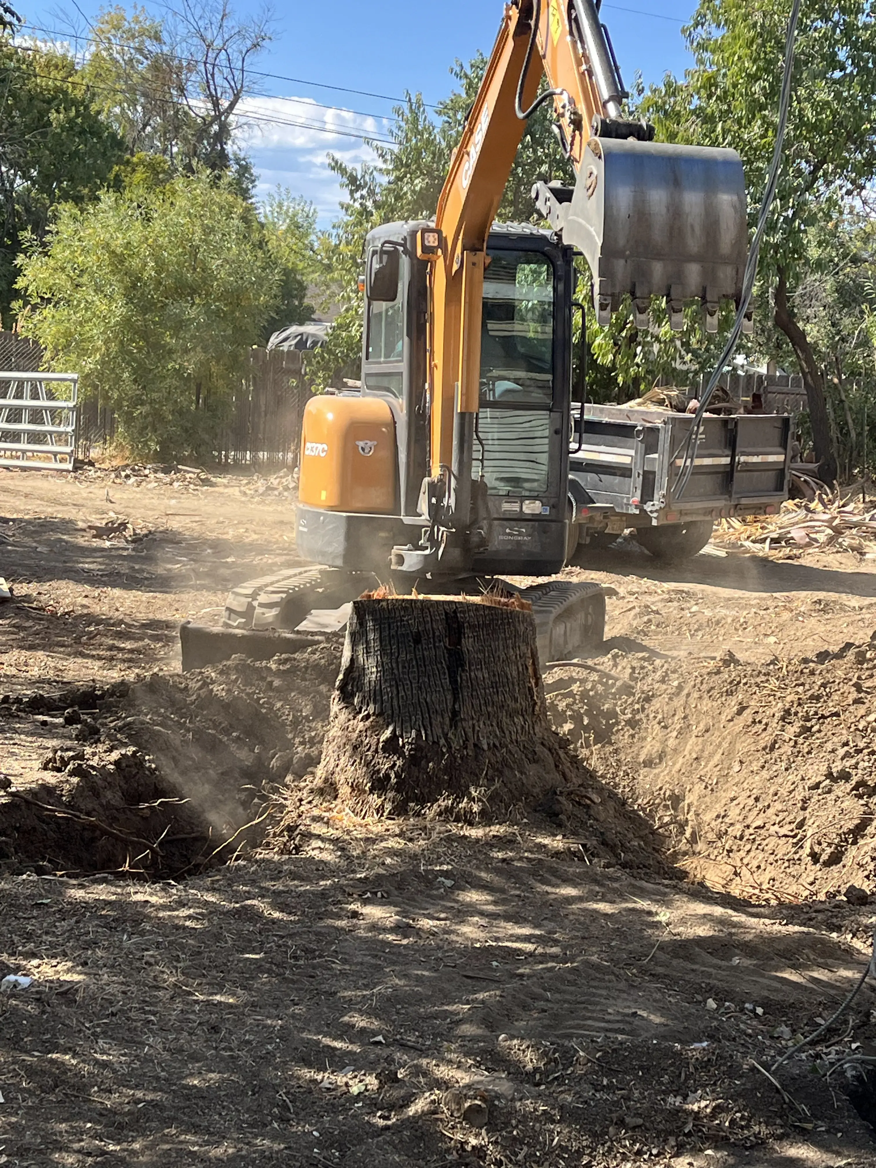Backhoe performing excavation work for a landscaping project