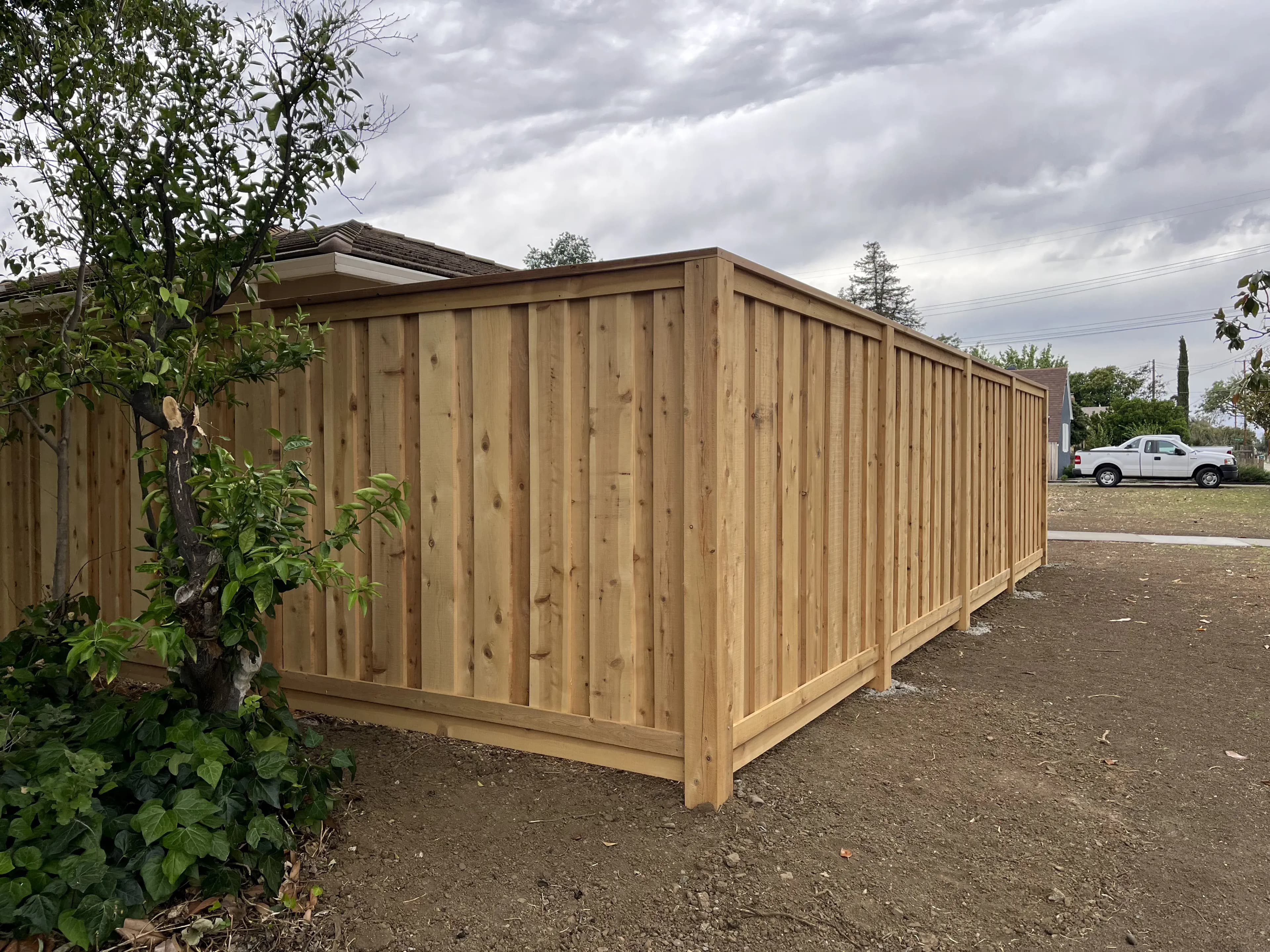 Close-up of a sturdy wooden privacy fence panel and post